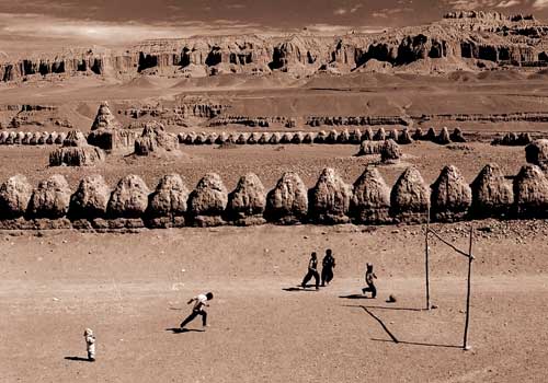 Tibetan teenagers are playing ball on a field at an elevation of 3800 meters,close to the relics of Guge Kingdom in Zhada County of Ngari Prefecture.